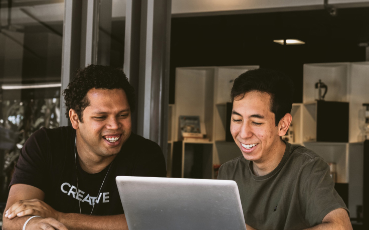 Two men looking at a computer
