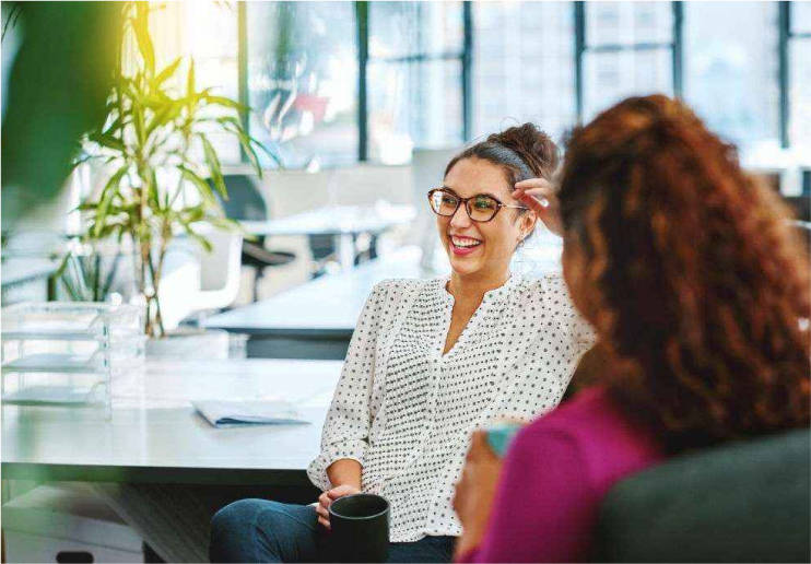 Two women laughing in an office